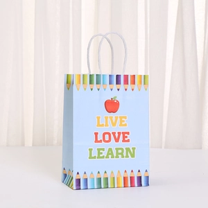 School bus kraft paper gift bag with 'LIVE LOVE LEARN' print and pencil patterns