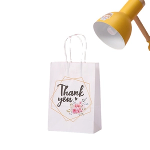 White kraft paper gift bag with Thank You floral design and white rope handles