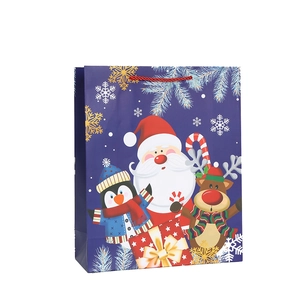 Christmas gift bag with Santa and penguin prints, blue paper shopping bag with red rope handles