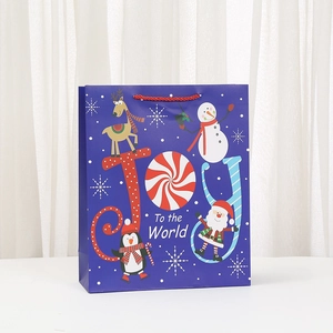 Christmas gift bag with Joy To the World print and festive Santa Claus cartoon motifs