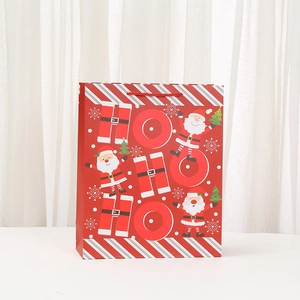 Christmas paper gift bag featuring cartoon Santa Claus and festive HO HO HO print design