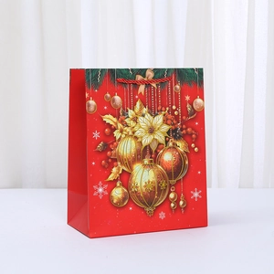 Christmas gift bag in festive red with reindeer gold ornaments and red rope handle