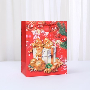 Christmas red paper gift bag with reindeer print and woven handles for holiday shopping