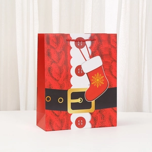 Red Christmas Santa suit paper gift bag with white snowflakes and rope handles