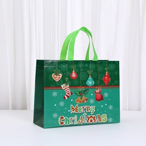 Detail of waterproof Christmas non-woven gift bag with striped design and festive prints