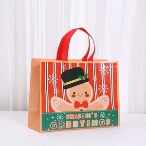 Waterproof non-woven Christmas gift bag with gingerbread man and red wide handles
