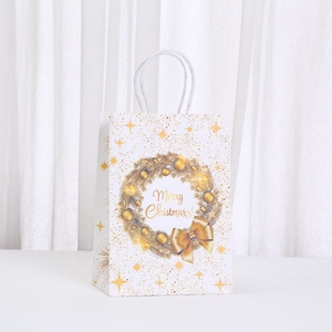 Elegant white Christmas paper gift bag with golden wreath and Merry Christmas greeting