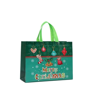 Waterproof non-woven Christmas gift bag with festive Merry Christmas print and handle