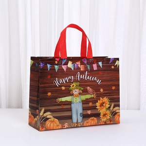 Detail of Happy Autumn non-woven gift bag with harvest scarecrow and pumpkin print