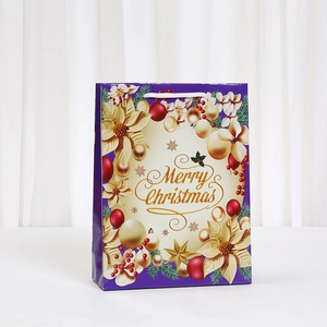 Purple Christmas gift bag with golden floral patterns and Merry Christmas text