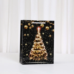 Detail of black Christmas gift bag with gold spiral tree and white rope handle