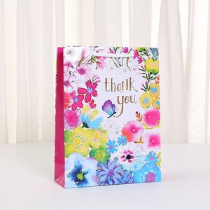 Floral thank you gift bag with watercolor flower patterns and white rope handles
