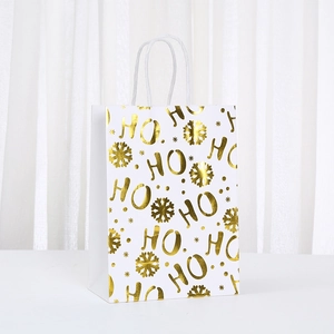 White Christmas kraft paper gift bag with gold HO HO HO lettering and snowflakes