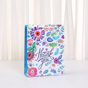 Floral Thank You paper gift bag with colorful bohemian flower patterns and white handles