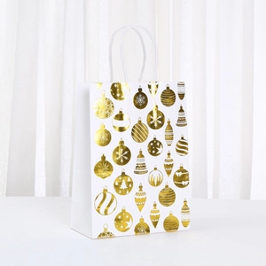 White kraft paper gift bag with gold foil Christmas ornaments and twisted rope handle