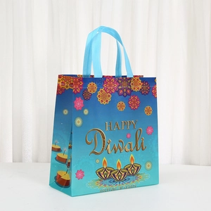 Blue Diwali gift bag with Happy Diwali print and mandala patterns on a white table