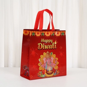 Waterproof non-woven Diwali gift bag with Ganesha print and red handles for party favors