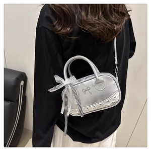 Silver bowling bag with lace trim, metal bow and checkered ribbon shown on model
