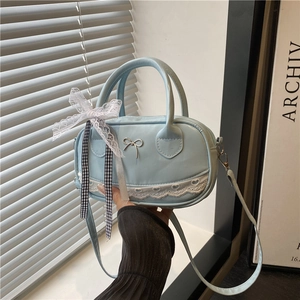 Light blue bowling handbag with lace heart trim and metallic bow on leather