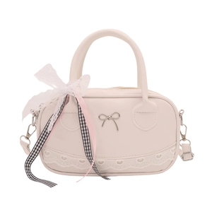 Chic cream bowling bag with bow metal buckle and heart lace trim on white background