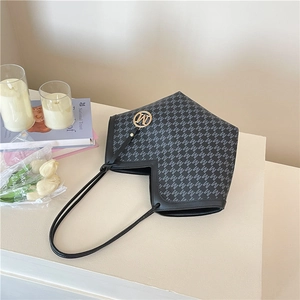Chic V-cut tote bag with black leather trim, monogram canvas, and gold M pendant