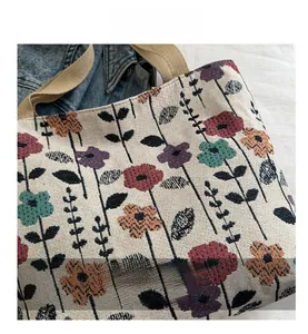 Close-up of woven fabric texture with colorful floral patterns on a stylish tote bag