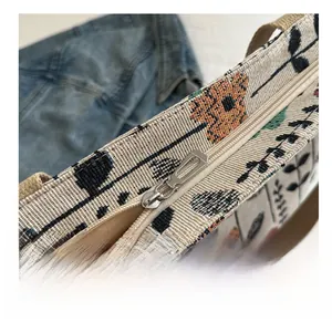 Close-up of smooth silver metal zipper and retro floral print on canvas tote bag