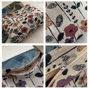 Detail view of floral jacquard tote bag texture with zipper and woven handles