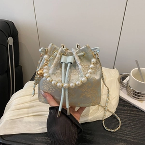 Light blue jacquard bucket bag with gold tree pattern and pearl top handle