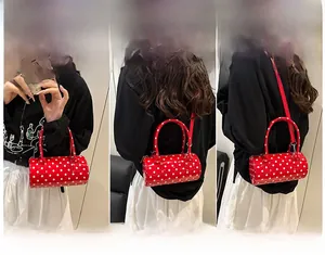 Polka dot barrel bag shown in three styles: handbag, shoulder bag, and crossbody mode
