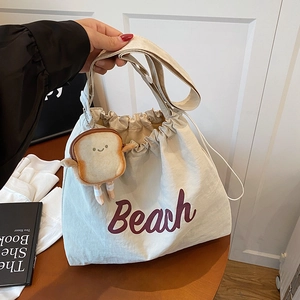 Off-white canvas tote bag with purple Beach print and cute toast plush pendant