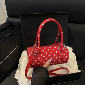Red and white polka dot cylinder handbag with silver hardware on white silk lining