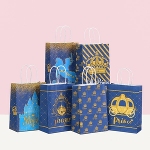 Detail of 6 prince-themed blue paper gift bags with gold glitter patterns and handles