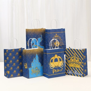 Set of dark blue Prince gift bags with gold foil crown, carriage, and castle designs