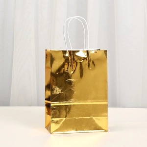 Glossy golden laser kraft paper gift bag with white rope handles for holiday shopping