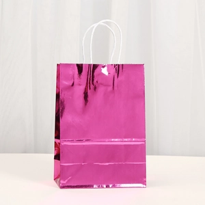 Detail of rose red metallic gift bag with glossy mirror finish and white rope handles
