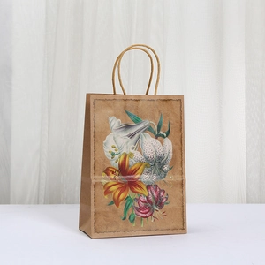 Brown kraft paper gift bag featuring elegant lily floral print and sturdy twisted handles