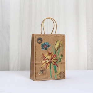 Vintage kraft paper gift bag with floral prints and rustic rope handles for parties