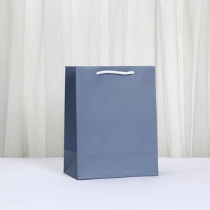 Minimalist matte dark grey-blue paper gift bag with white cotton rope handles