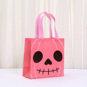 Detailed close-up of pink Halloween non-woven gift bag featuring a black skull print