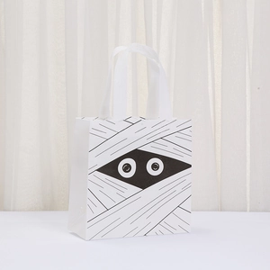 Detail of white non-woven Halloween mummy gift bag with black bandage print and cute eyes