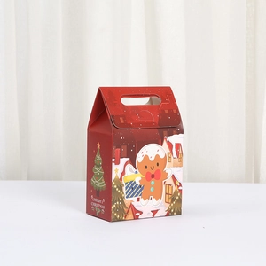 Red Christmas gingerbread man gift box with festive handle and snowy house illustration