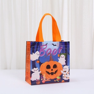 Detail of Halloween non-woven gift bag with pumpkin, ghost prints and orange handles