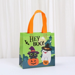 Detail of Halloween non-woven gift bag with HEY BOO print and orange handles
