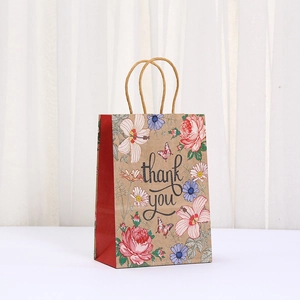 Close-up of kraft paper gift bag with floral prints, butterfly, and thank you text