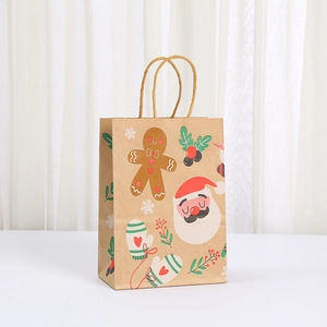 Close-up of Christmas brown kraft paper gift bag with festive gingerbread and Santa prints