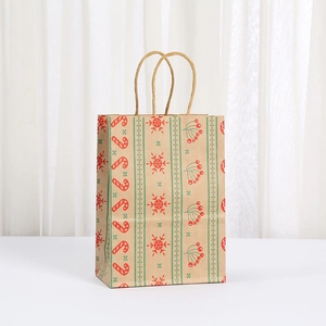 Close-up of Christmas kraft paper gift bag with festive candy cane and snowflake patterns