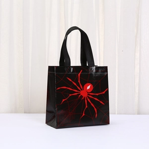 Detail of black non-woven tote bag with red spider print and woven handles