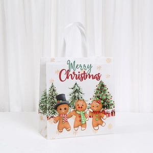 White Christmas non-woven gift bag featuring gingerbread men and Merry Christmas print