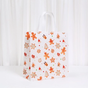 Christmas non-woven gift bag featuring festive gingerbread man and tree prints
